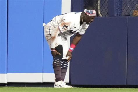 Marlins center fielder Davis is carted off the field with an apparent knee injury